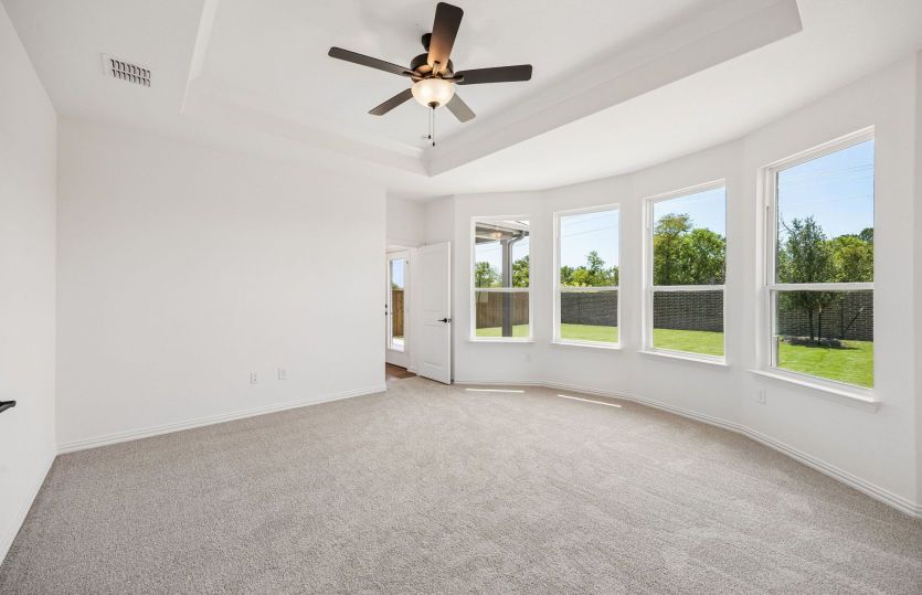Primary bedroom with bay windows