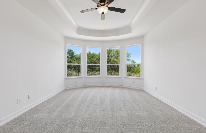Primary bedroom with bay windows