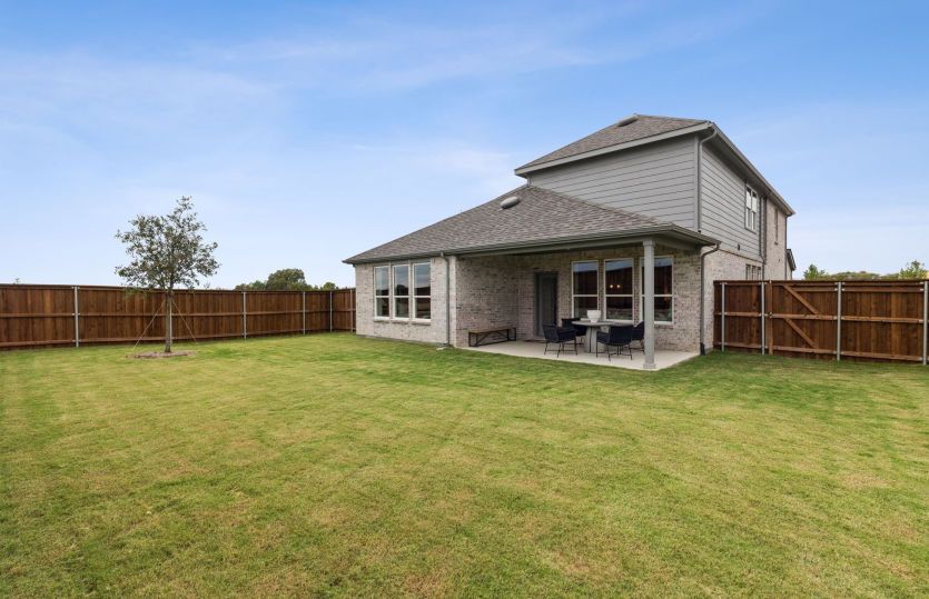 Built-in covered back patio and fenced-in yard *model representation