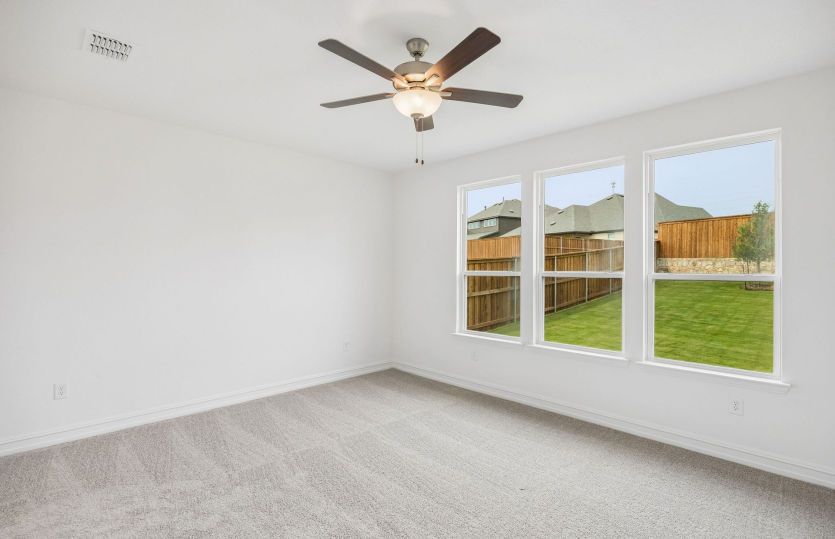 Primary bedroom with large windows