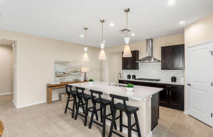 Pendant lights over the island give this home a modern feel