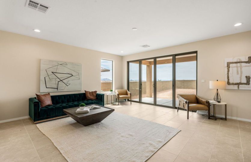 Large living area with sliding door access to covered patio