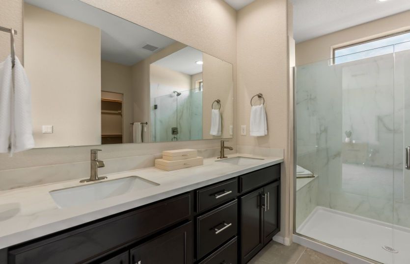 Owner's bathroom with dual sinks and modern frameless glass shower