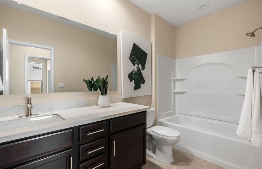 Guest bathroom with plenty of cabinet and counter space