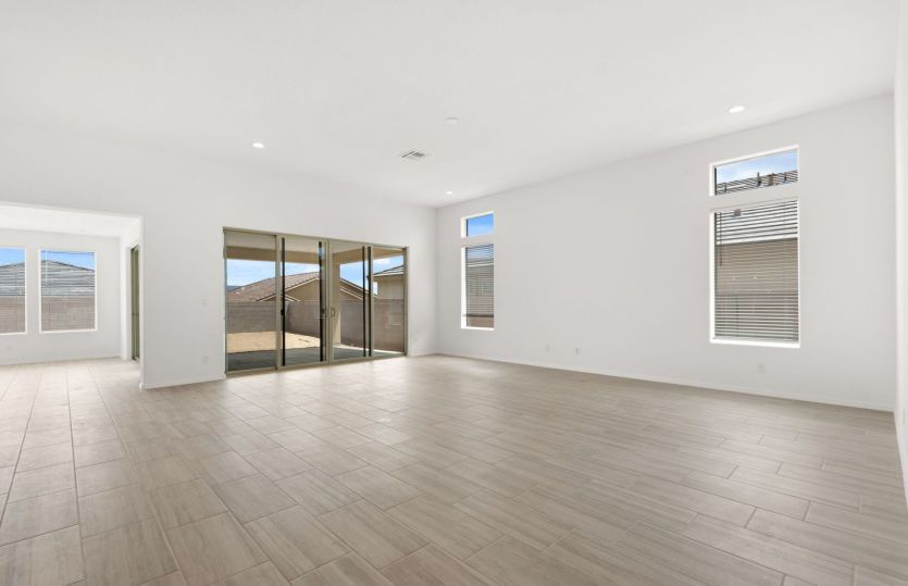 Large windows and sliding glass door provide ample natural light