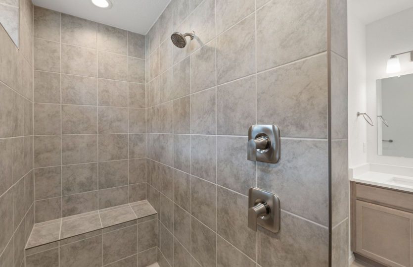 Spa-inspired tile walk-in shower in owner's bath