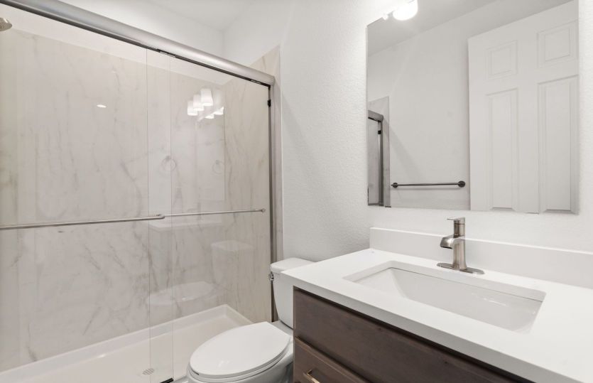 Guest suite bathroom with framed glass shower