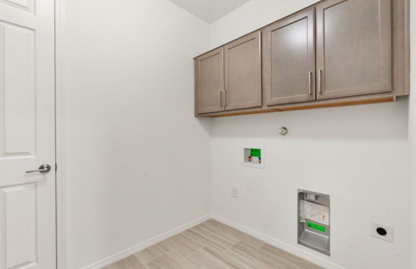 Laundry room with cabinets for additional storage and convenience