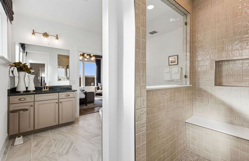 Beautiful shower and double vanity in primary bath*model representation