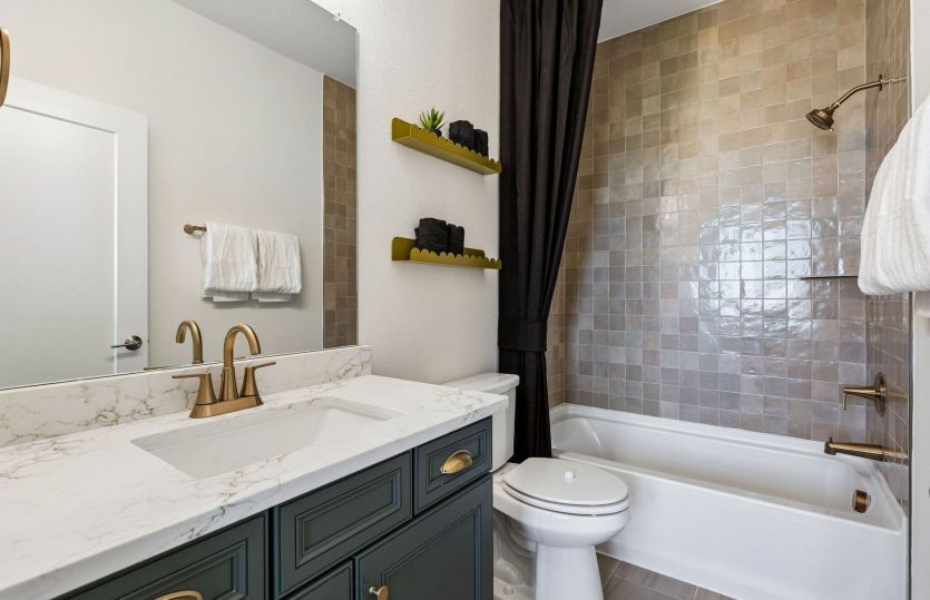 Secondary bath with tile surrounded shower*model representation