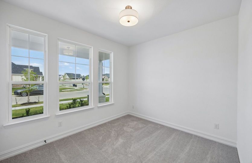 Secondary bedroom with large windows on first level