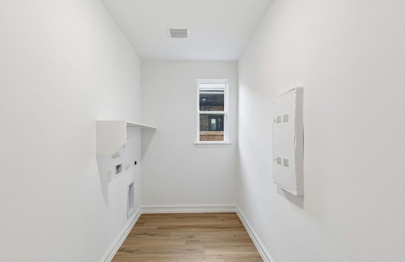 Laundry room with built-in shelving