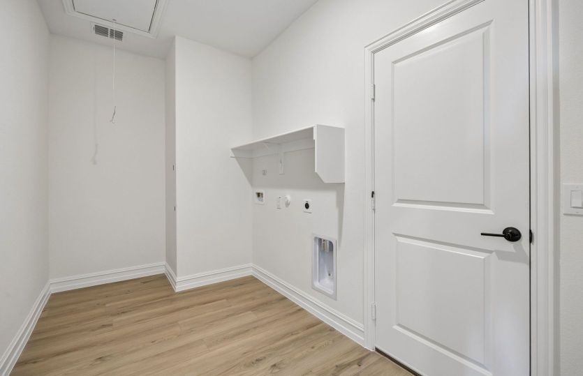 Laundry room with built-in shelving