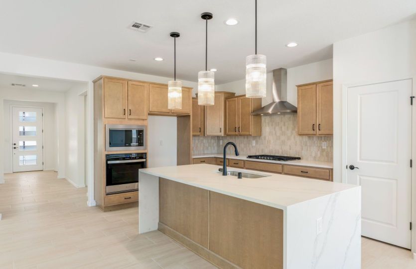 Warm toned kitchen with modern pendant lights and chef's kitchen upgrade