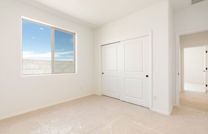 Secondary bedroom featuring generous closet space and natural light