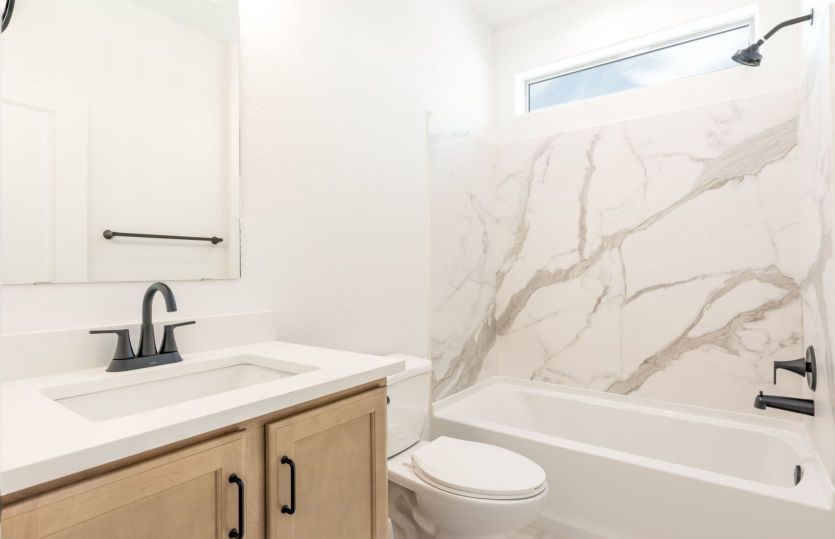 Secondary bathroom featuring shower/tub combo