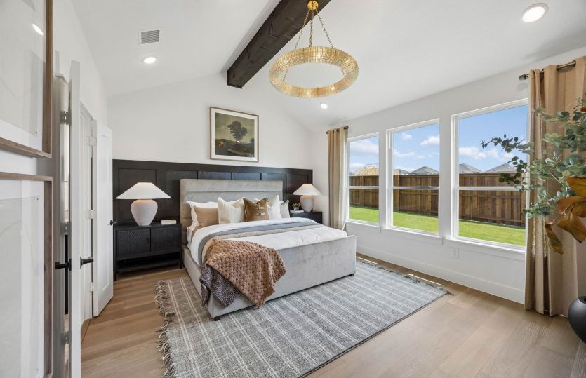 Primary bedroom with large windows