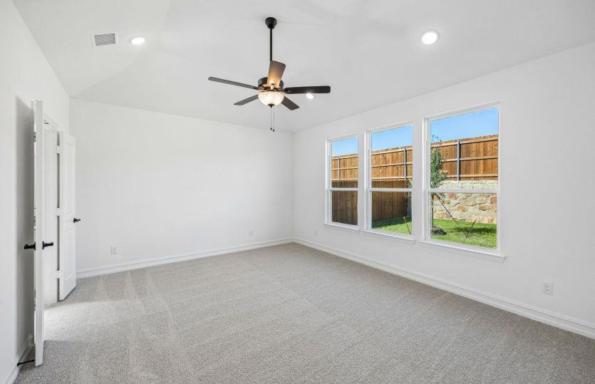 Primary bedroom with large windows