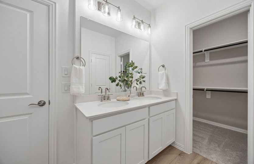Double vanity and walk-in closet in primary bedroom