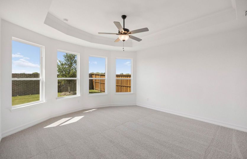 Primary bedroom with bay windows