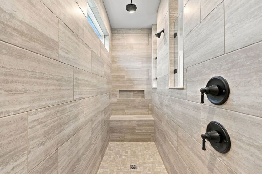 Walk-in shower adds a sleek and refreshing touch to the owner’s bath.