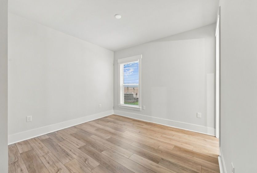 Comfortable guest bedroom with convenient access to nearby bathroom.