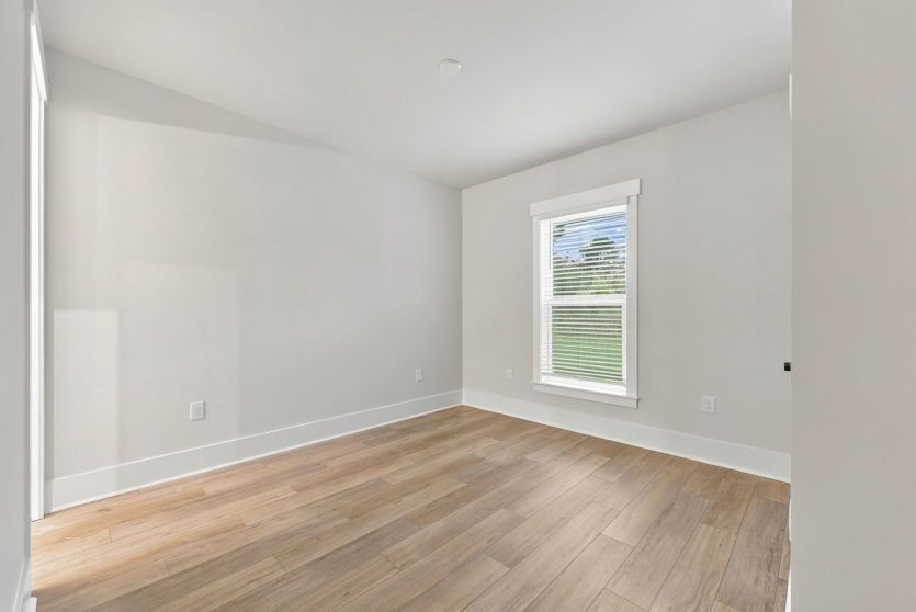 Versatile secondary bedroom with natural light and ample closet space.