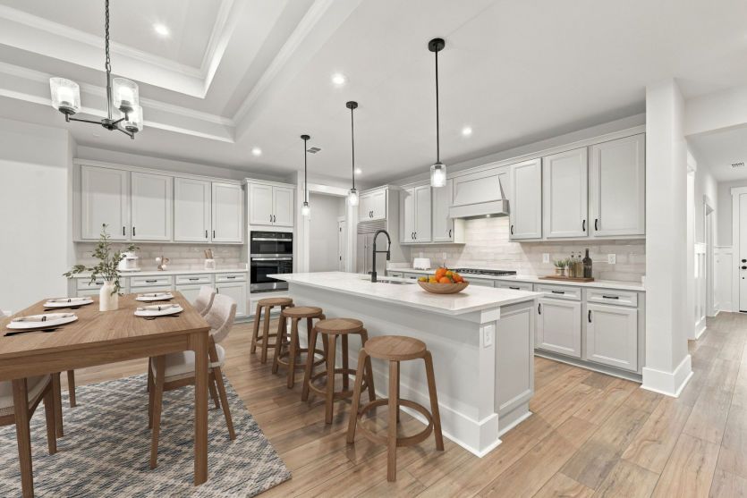 Bright open kitchen and family room with large island and connected seating space.