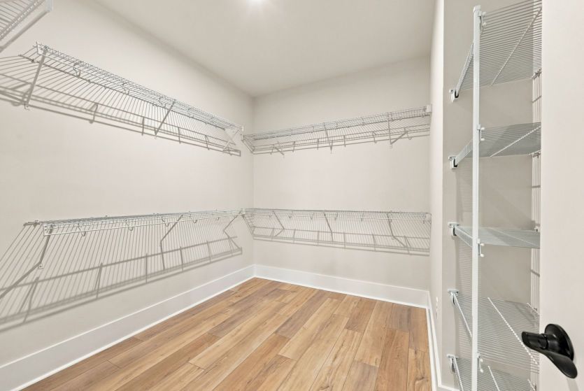 Walk-in closet with room to keep everything neatly organized and within reach.