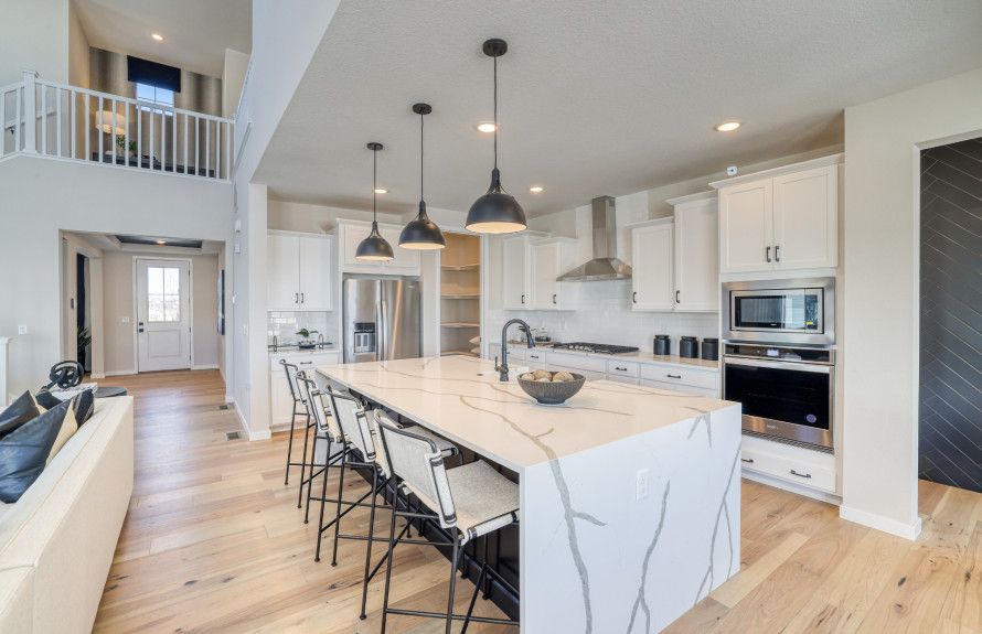The kitchen boasts style and functionality with built-in appliances and a spacious corner pantry.