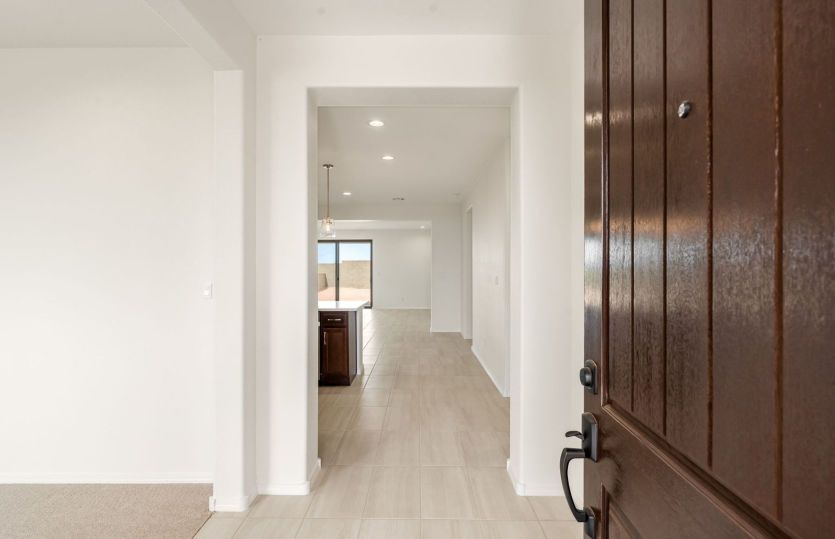 Welcoming entryway with den to the left
