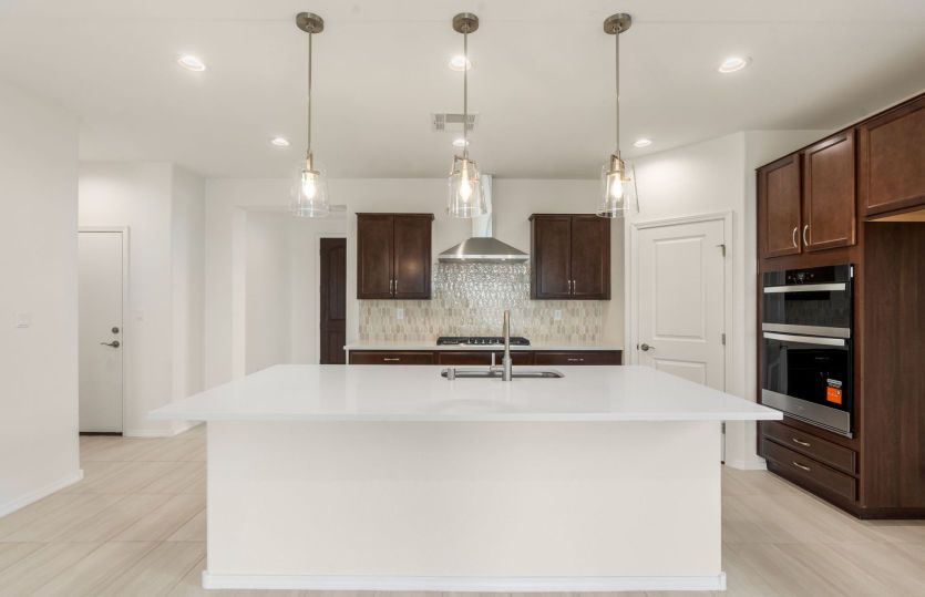 Dark cabinets and light counter tops add contrast to space