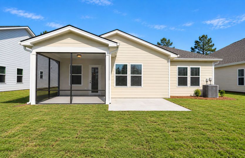 Back exterior featuring an extended unscreened patio.