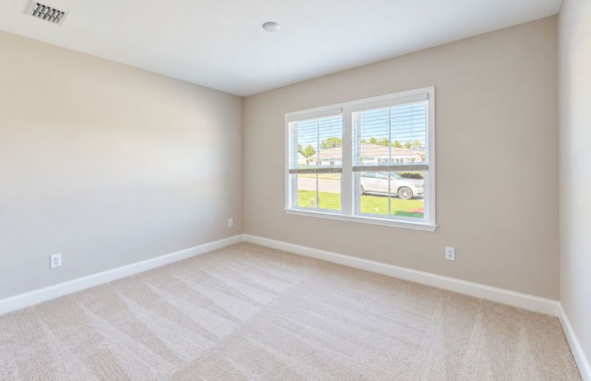 Welcoming second bedroom with flexible living space.