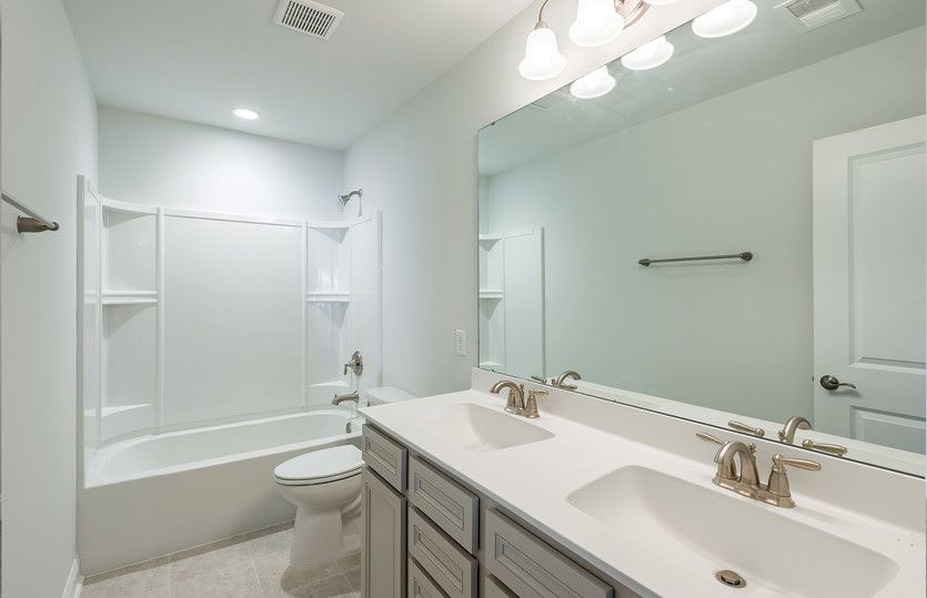 Guest Bathroom with dual-sink vanity and shower with tub