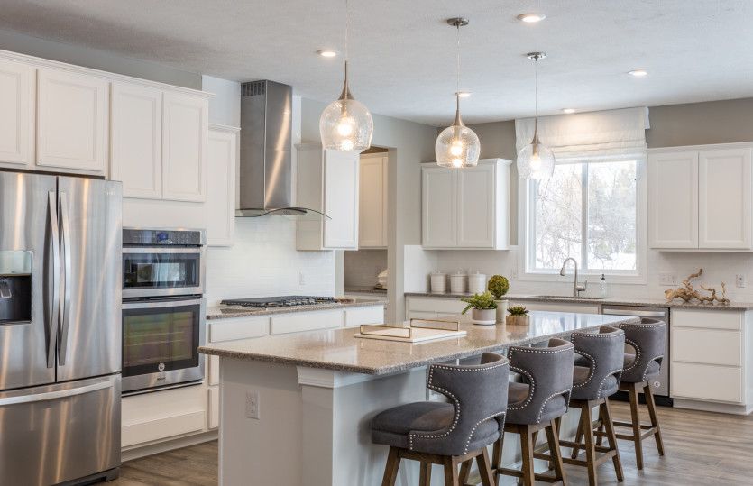 Gourmet Kitchen with White Cabinets and Pendant Lighting