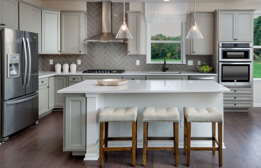 Gourmet Kitchen with White Cabinets and Pendant Lighting