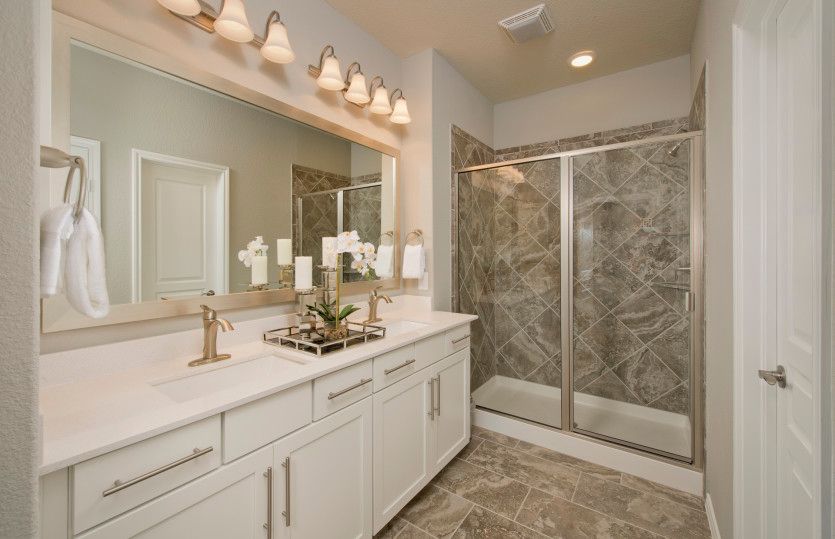 Owner's bath with double vanity and tile-surround shower