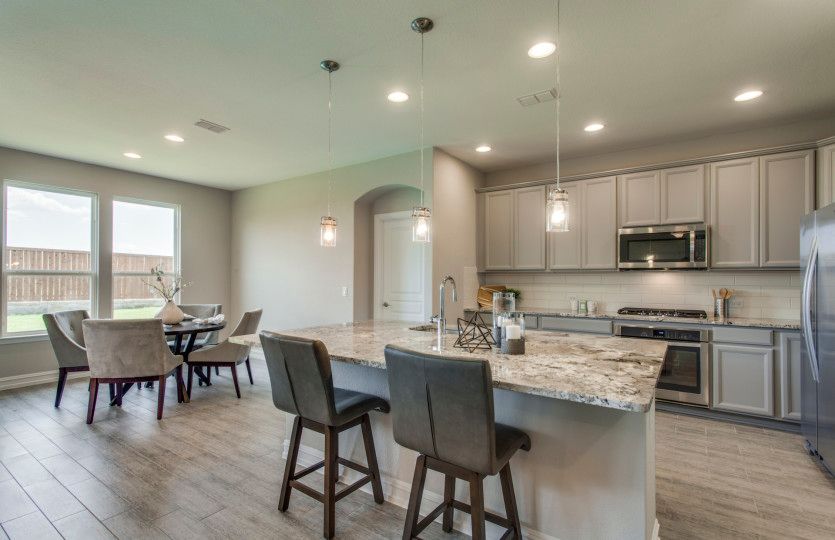Spacious kitchen island overlooks the open floorplan and makes a perfect space for entertaining