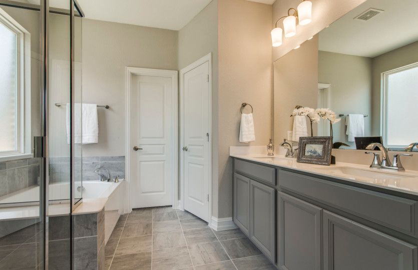 Owner's bathroom with double vanity and tile floors