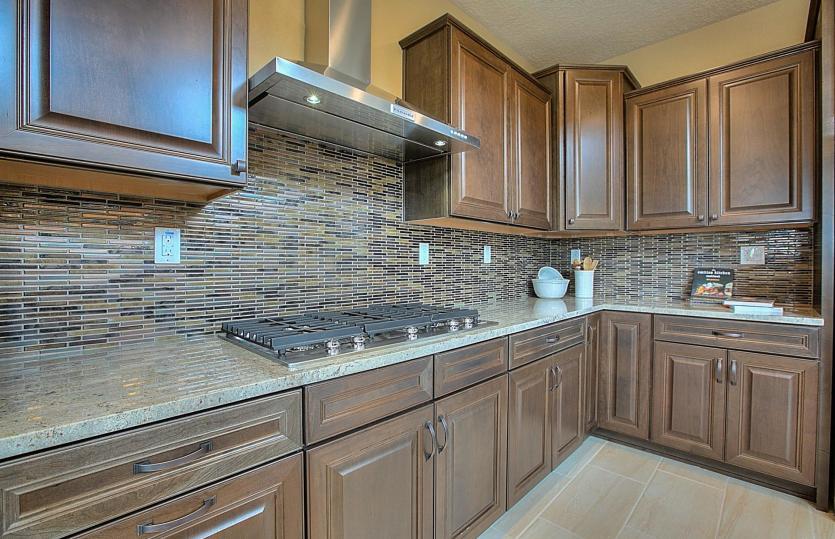 Beautifully accent your kitchen with tile backsplash selections and different cabinet hardware.
