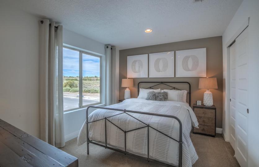Spacious secondary bedroom with bright window is suitable for overnight guests or family members.