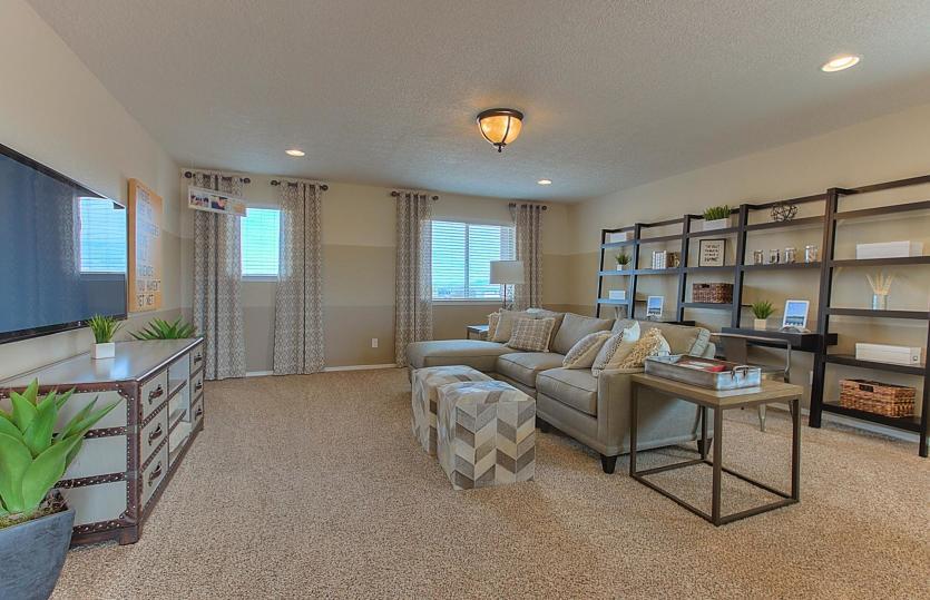 Spacious loft shown as a flexible room for movie nights, game nights, or a play room.