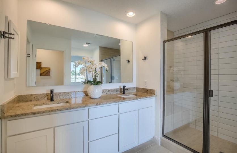 The private owner's bath complete with dual sinks on the granite vanity and tile shower with seat pl