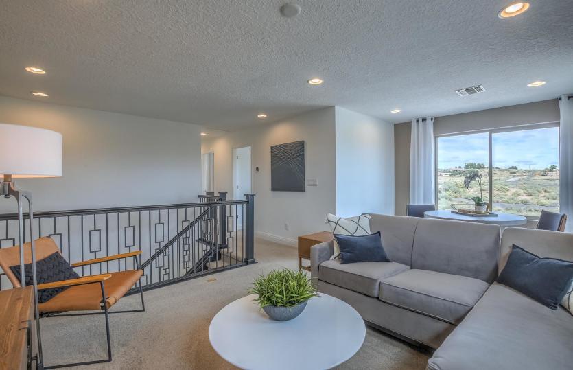 The wrought-iron stair spindles take you to the upstairs and loft living area for additional functio