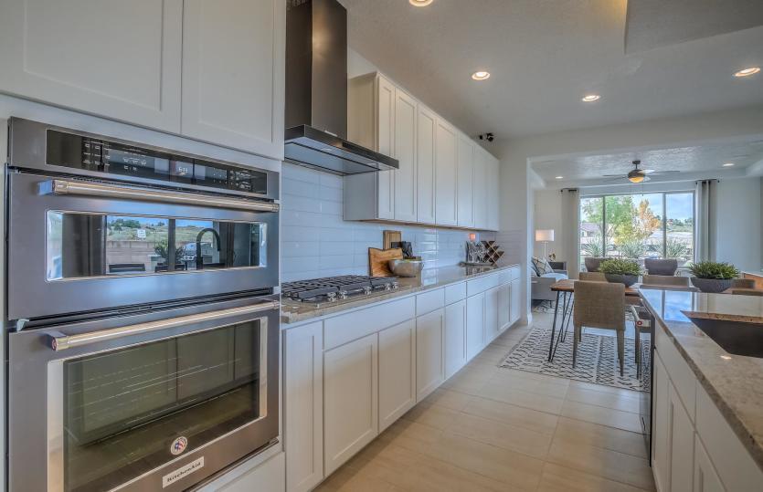 Built-in black stainless Kitchenaid® appliances with range, microwave, and gas cooktop with vent hoo