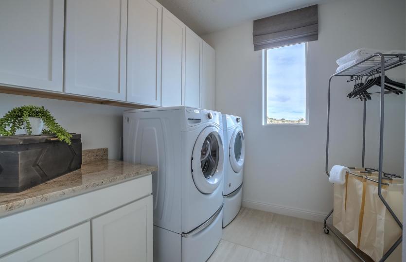 Laundry room offers functionality as well as space and lighting to make chores just a little more en