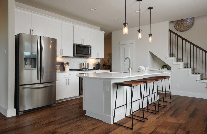 Spacious island kitchen with pendant lighting*model representation
