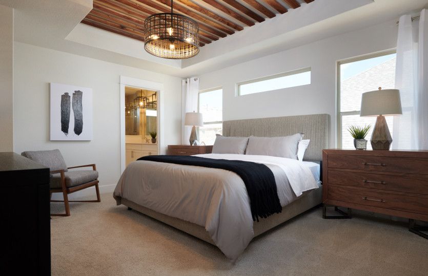 Owner's suite with large windows and private bath*model representation