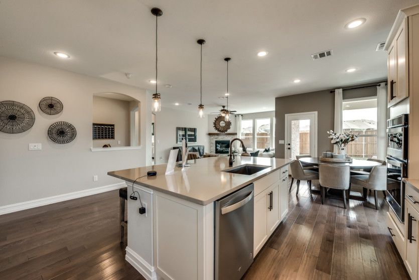 Spacious kitchen with pendant and recessed lighting